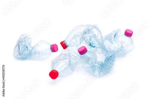 Konstfotografi Empty plastic water bottles scaled for recycling isolated on white background