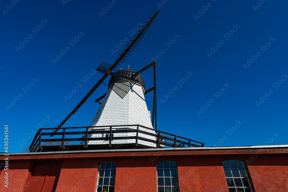Old Danish mill in the town of Ry. The White Church, in contrast to the red woodwork, and the blue sky, one morning in the spring. Old Danish mill in the town of Ry. The White Church, in contrast to the red woodwork, and the blue sky, one morning in the spring.