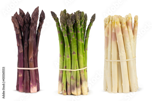Three bunches of different fresh asparagus isolated on white. Purple white and green asparagus. photo