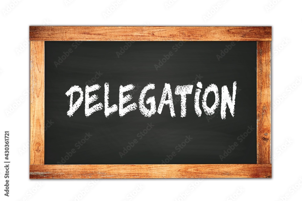 DELEGATION text written on wooden frame school blackboard. DELEGATION text written on wooden frame school blackboard.