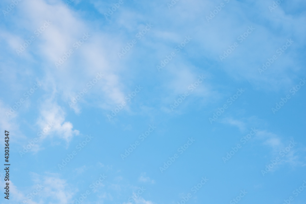 Beautiful blue sky with white fluffy clouds. Can be used as natural background, wallpaper, textile