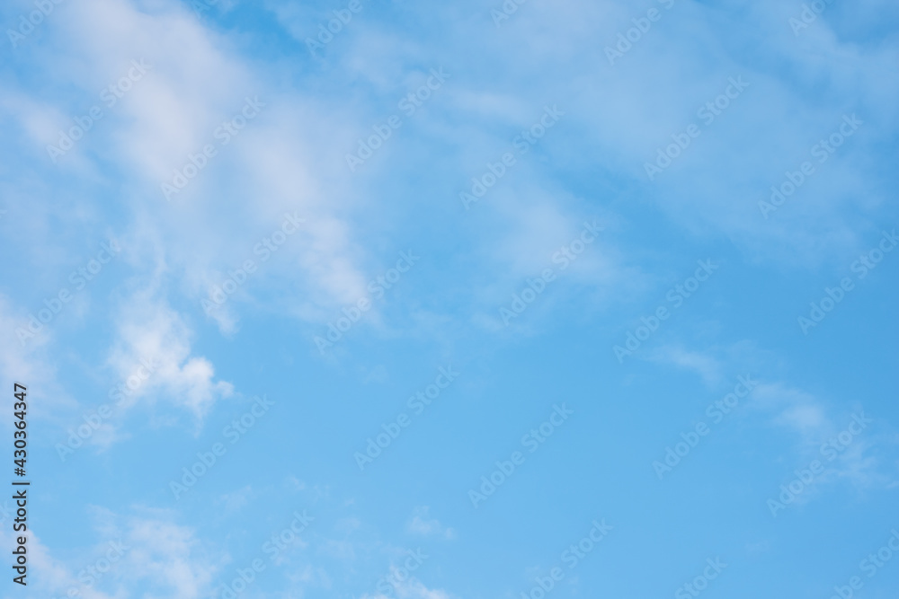 Beautiful blue sky with white fluffy clouds. Can be used as natural background, wallpaper, textile Beautiful blue sky with white fluffy clouds. Can be used as natural background, wallpaper, textile