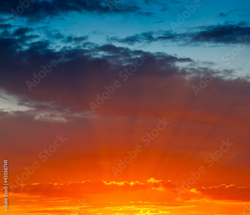 Beautiful orange and yellow clouds in the summer sunset sky