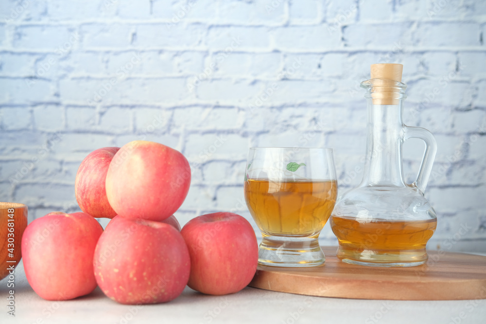 apple vinegar in glass bottle with fresh green apple on table 