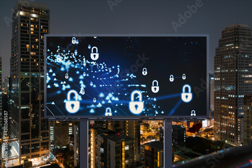 Padlock icon hologram on road billboard over panorama city view of Bangkok at night to protect business  Southeast Asia. The concept of information security shields.