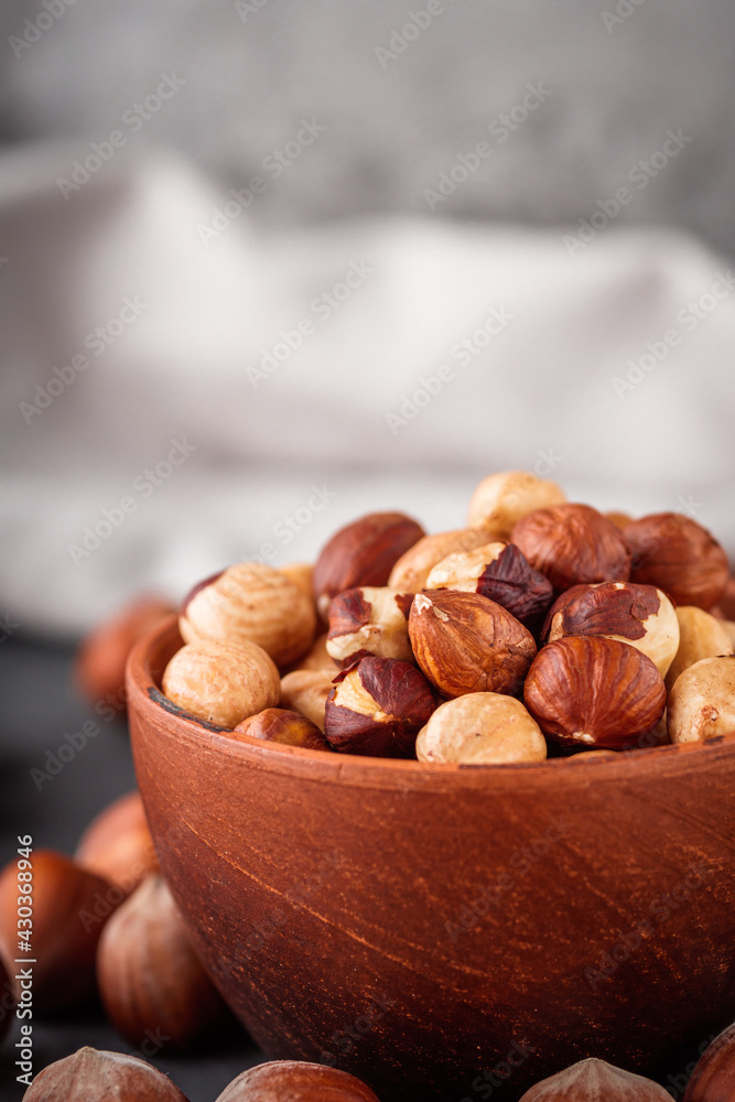 Fototapeta premium fresh natural hazelnuts on a dark stone background