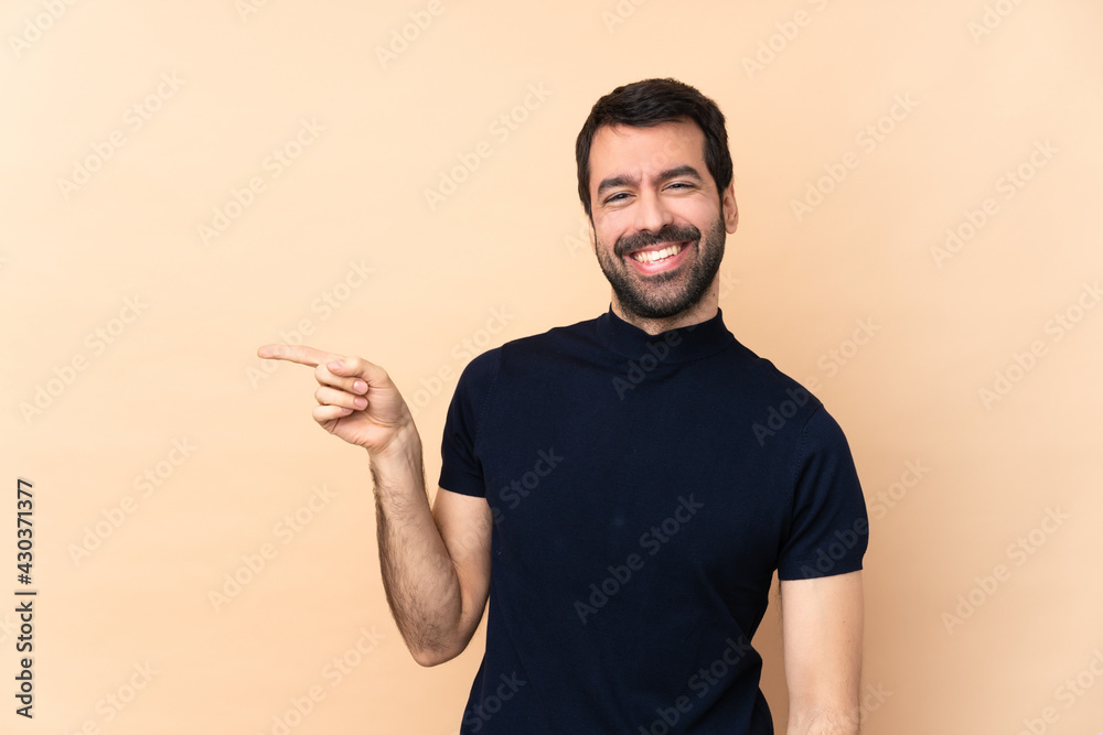 Caucasian handsome man over isolated background pointing finger to the side Caucasian handsome man over isolated background pointing finger to the side