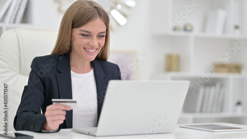 Online Payment Success on Laptop for Businesswoman in Office 