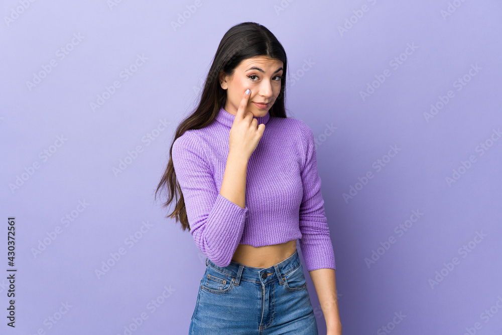 Young brunette woman over isolated purple background showing something Young brunette woman over isolated purple background showing something