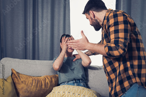 Fotografi Newly married young couple where a man attacks and mentally abuses her young wif