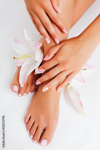 manicure pedicure with flower lily closeup isolated on white perfect shape hands spa salon © iordani