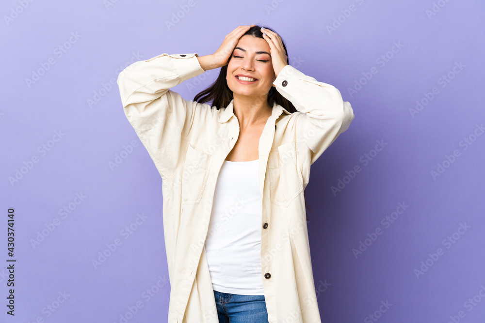 Young brunette woman over isolated purple background laughing Young brunette woman over isolated purple background laughing