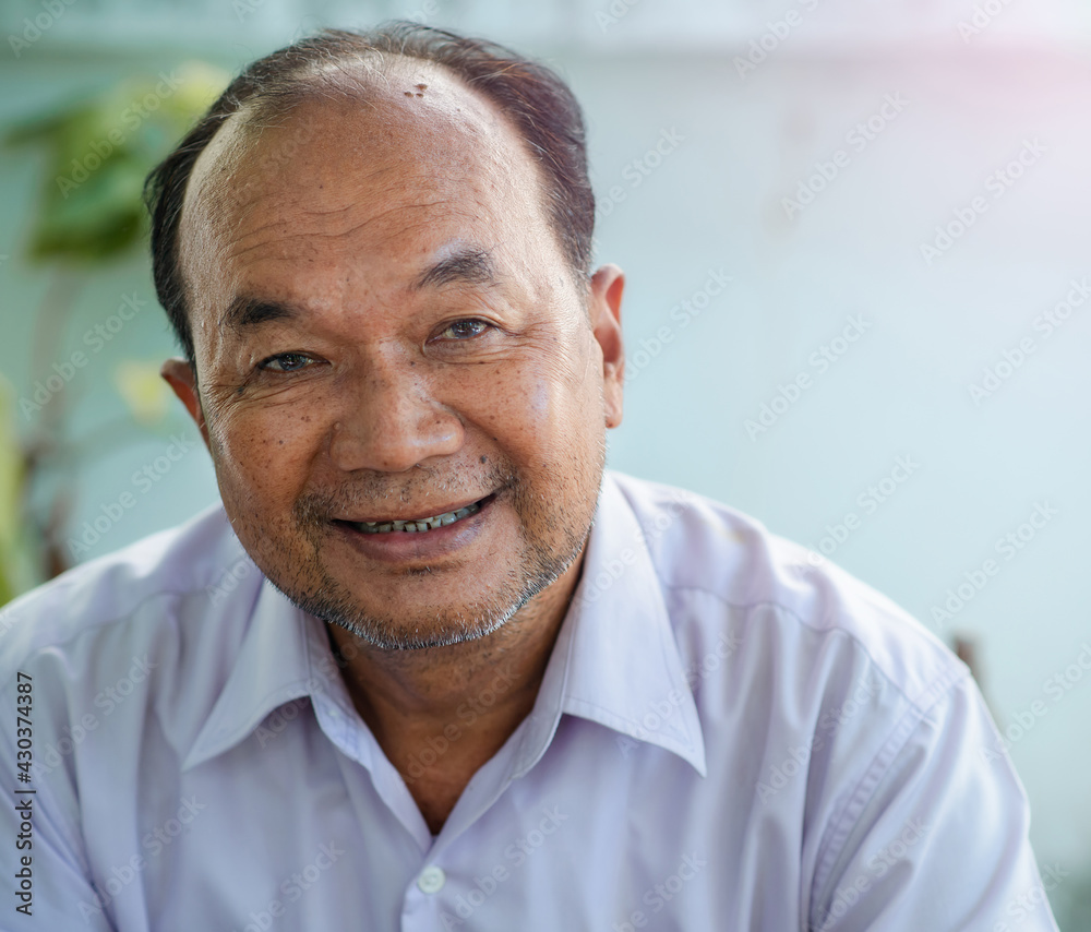 Happy smiling 60 year old elder senior man portrait