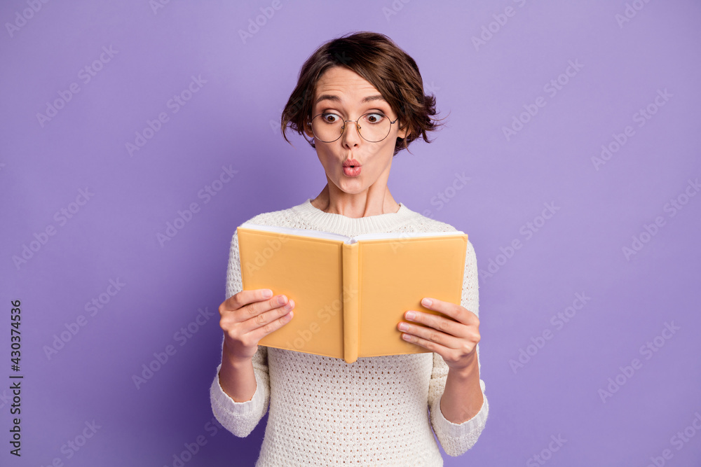 Photo portrait of amazed woman bob hair reading information whistle shocked isolated on bright violet color background Photo portrait of amazed woman bob hair reading information whistle shocked isolated on bright violet color background