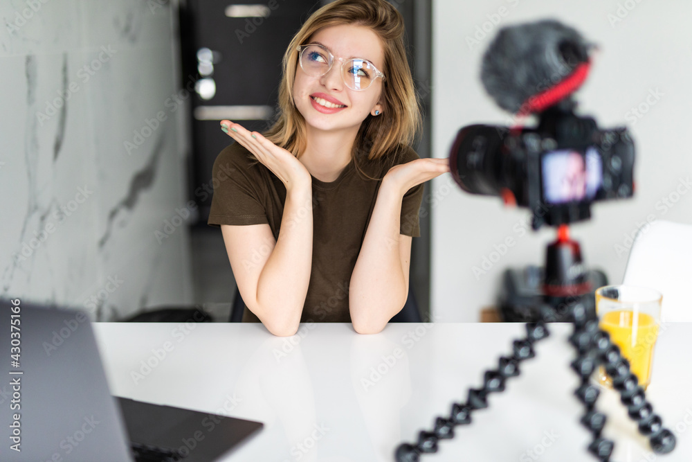 Modern influencer. Female vlogger making social media video while sitting indoors Modern influencer. Female vlogger making social media video while sitting indoors