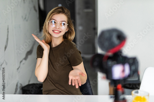 Modern influencer. Female vlogger making social media video while sitting indoors
