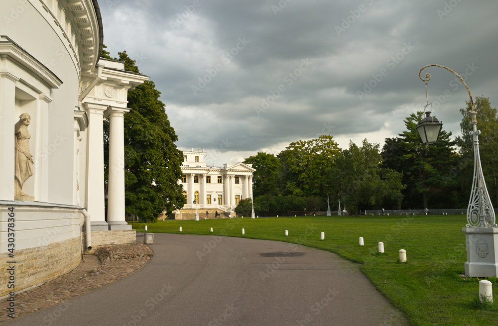 Obraz premium Saint Petersburg. The beautiful exterior of facade of the Elaginskiy Summer Palace surrounded by park green lawns and alleys on Elagin Island. Summer travel ang outdoors