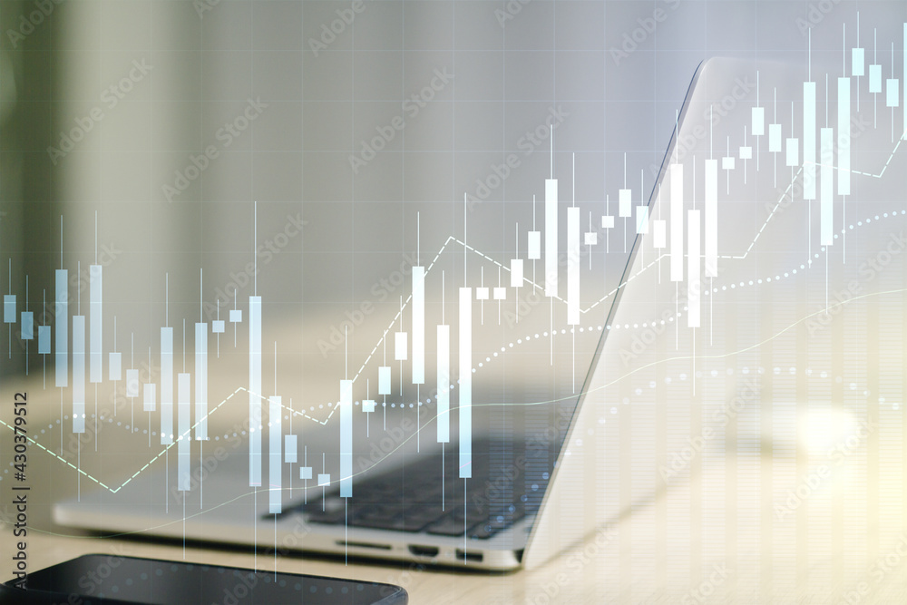 Multi exposure of abstract financial graph on laptop background, financial and trading concept Multi exposure of abstract financial graph on laptop background, financial and trading concept