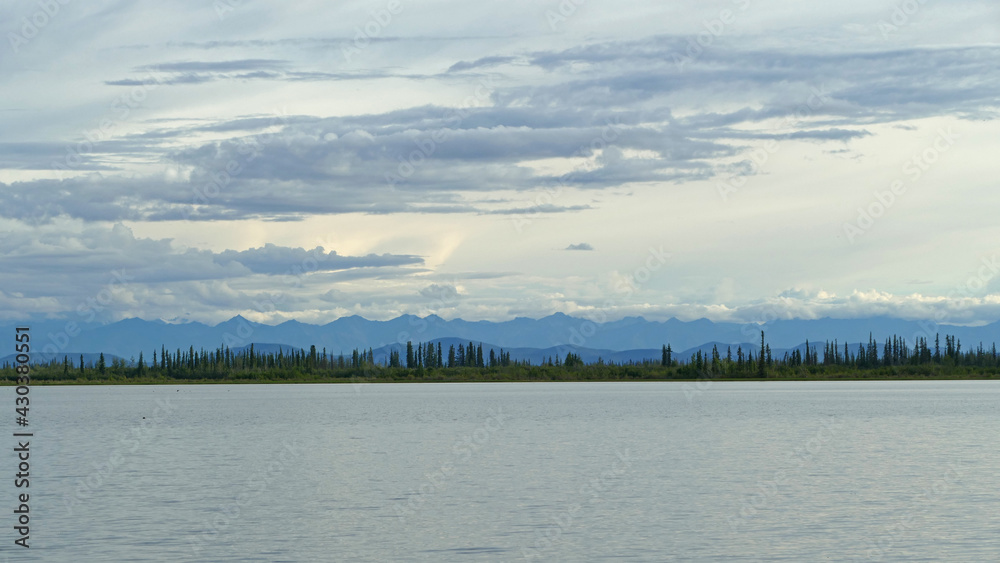 Panoramic Alaska landscape with lake, boreal forest and mountains