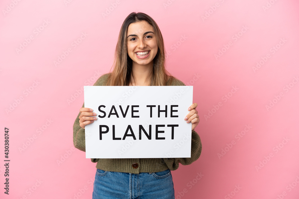 Young caucasian woman isolated on pink background holding a placard with text Save the Planet with happy expression Young caucasian woman isolated on pink background holding a placard with text Save the Planet with happy expression