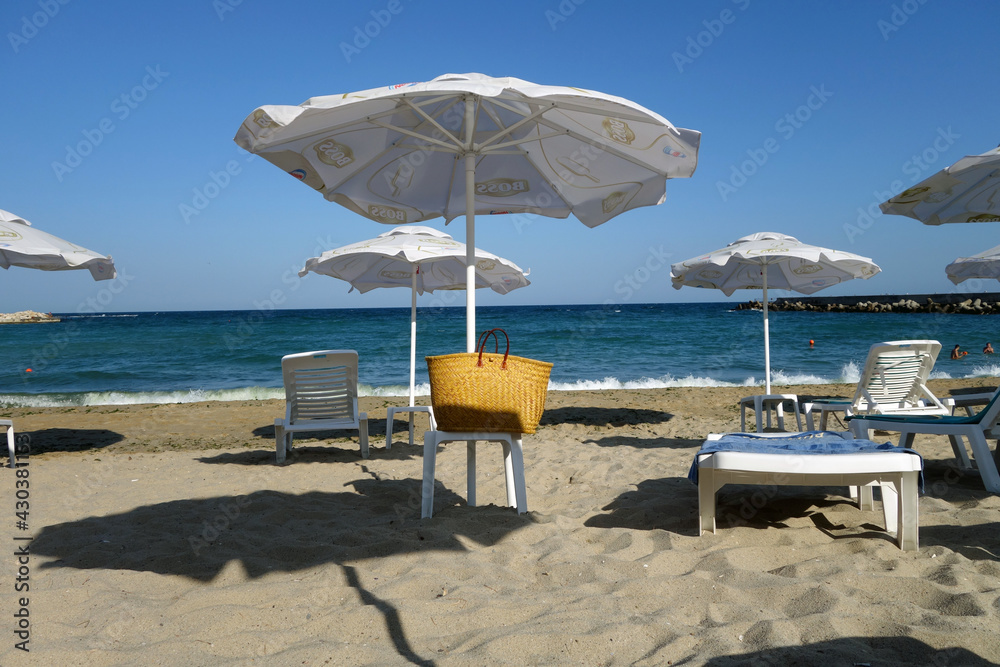 Beach umbrellas and black sea view.