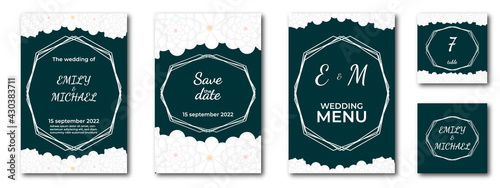 wedding invitation, menu and cards on the table on a dark background with geometric frame, lettering and white flowers framing. set of several items