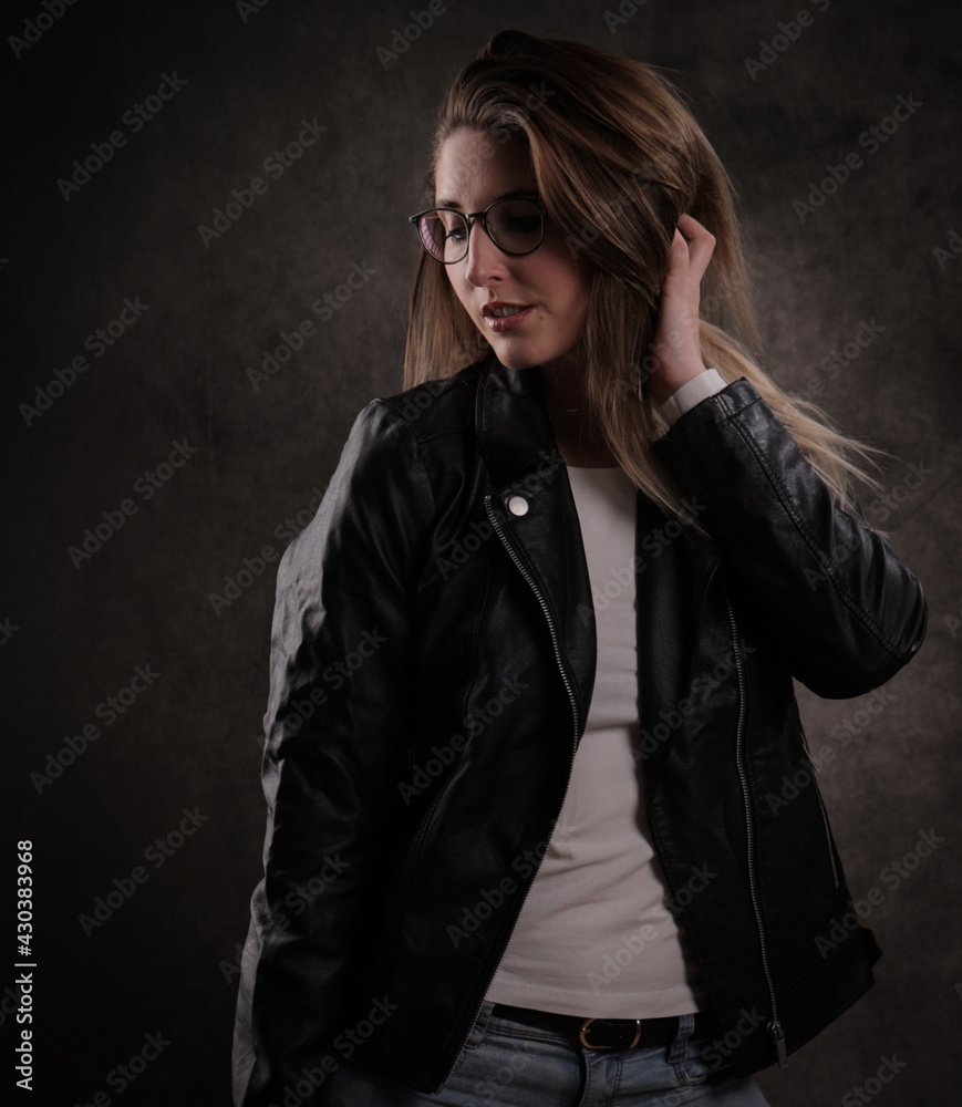 Attractive young woman poses for the camera - studio photography Attractive young woman poses for the camera - studio photography