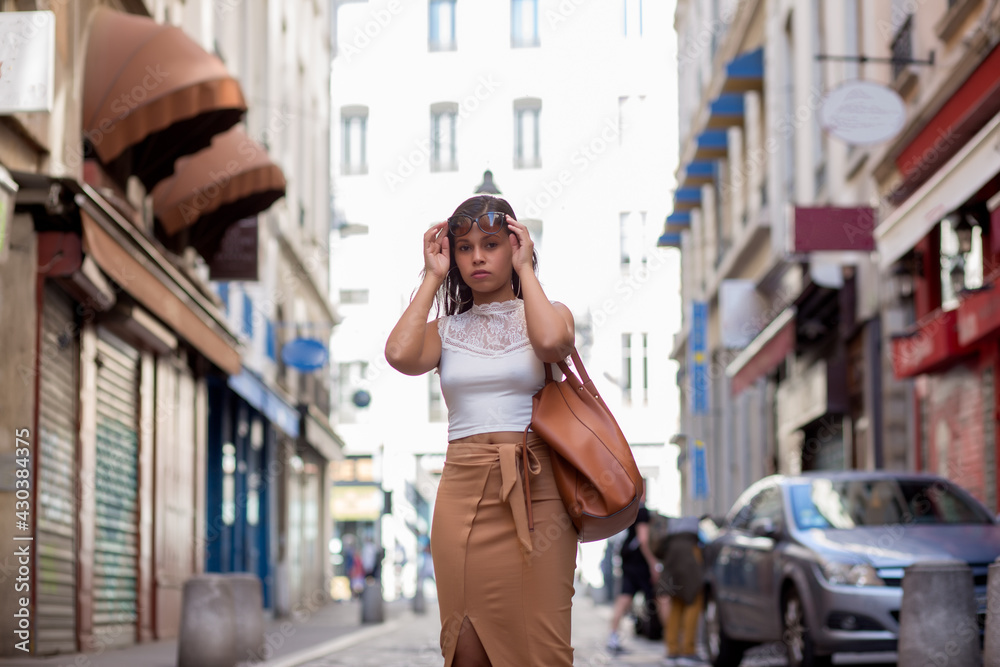 Fototapeta premium young latin american woman walking through the streets of the city of lyon france