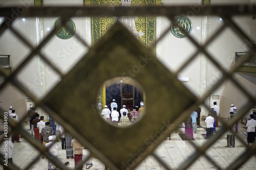 Situbondo, Indonesia - 26 April 2021 : indonesian muslim people (taraweeh) tarawih pray at Al Abror Mosque with social distancing photo