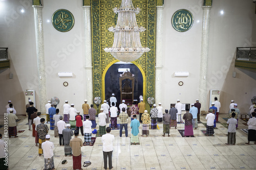 Situbondo, Indonesia - 26 April 2021 : indonesian muslim people (taraweeh) tarawih pray at Al Abror Mosque with social distancing photo