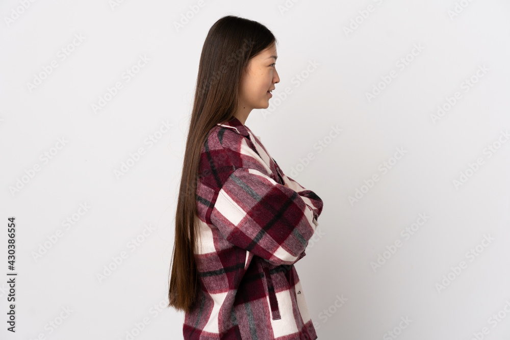 Young Chinese girl over isolated white background in lateral position Young Chinese girl over isolated white background in lateral position