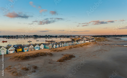 Aerial view of colourful houses in a row along the beach in Beach huts, Mudeford, Christchurch, Dorset, United Kingdom. photo