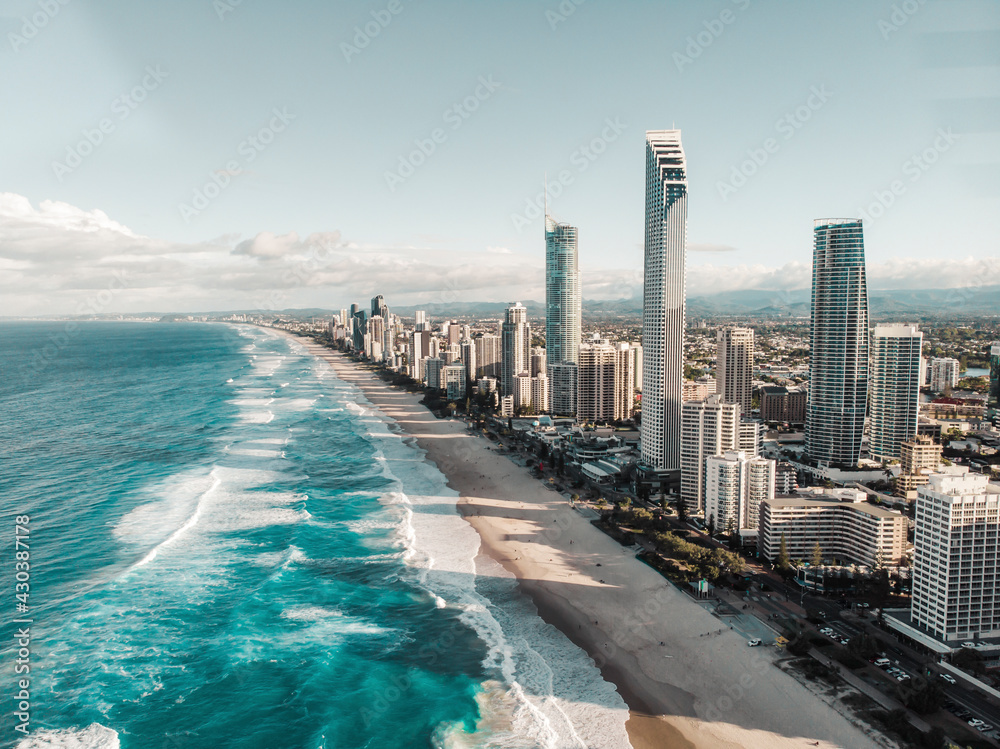 Aerial view of Surfers Paradise Skyline where the buildings are casting long shadows on the beach, Gold Coast, Australia.