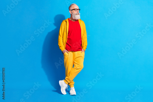 Full size photo of serious thoughtful minded mature man in glasses look copyspace thinking isolated on blue color background © deagreez