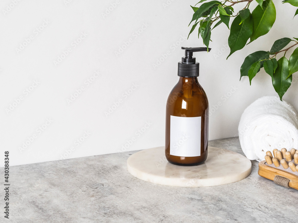 Brown glass bottle mockup for cosmetic products, cotton towels and wood massager Brown glass bottle mockup for cosmetic products, cotton towels and wood massager