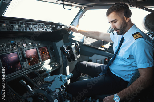 Handsome Caucasian pilot getting ready for the journey