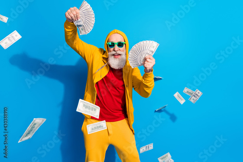 Photo of funky funny good mood handsome mature man in sunglass rick millionaire isolated on blue color background