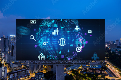 World planet Earth map hologram and social media icons on billboard over night panoramic city view of Kuala Lumpur, Malaysia, Asia. Networking and establishing new connections between people. Globe