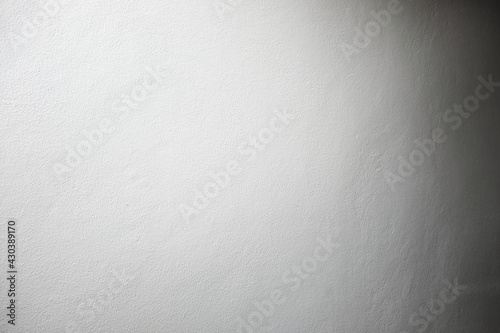 white color painted concrete wall in spot light and dark shadow on the opposite side