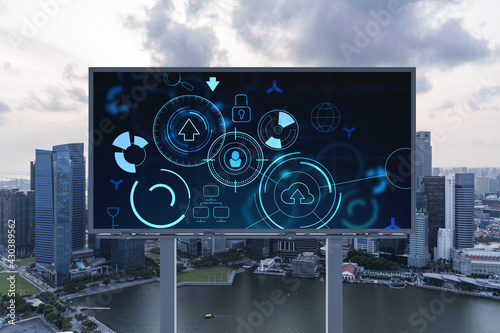 Glowing hologram of technological process on billboard, aerial panoramic cityscape of Singapore at sunset. The largest innovative hub of tech services in Southeast Asia.