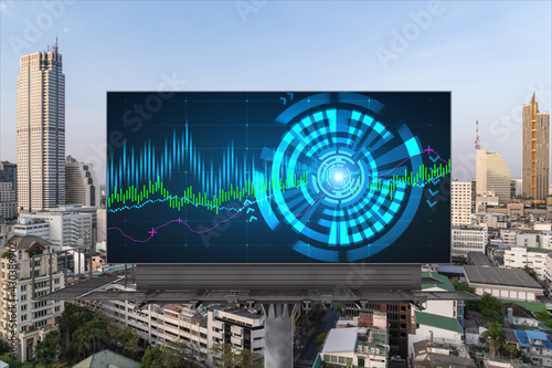 Forex and stock market chart hologram on road billboard over panorama city view of Bangkok. The financial center in Southeast Asia. The concept of international trading.