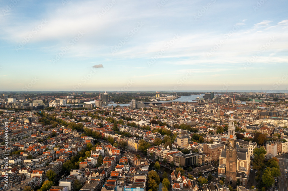 Aerial view of Amsterdam city center at sunset with river Buiten in background, Amsterdam, The Netherlands. Aerial view of Amsterdam city center at sunset with river Buiten in background, Amsterdam, The Netherlands.