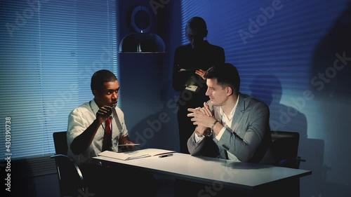 African police detective showing pictures of suspected robber's accomplice