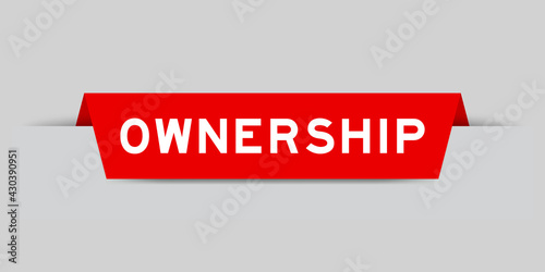 Red color inserted label with word ownership on gray background