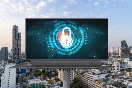 Padlock icon hologram on road billboard over panorama city view of Bangkok at sunset to protect business, Southeast Asia. The concept of information security shields.