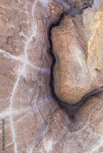 Aerial view of a deep and curved canyon with walking trail on-top, Nahal Barak river, Southern District, Israel. photo