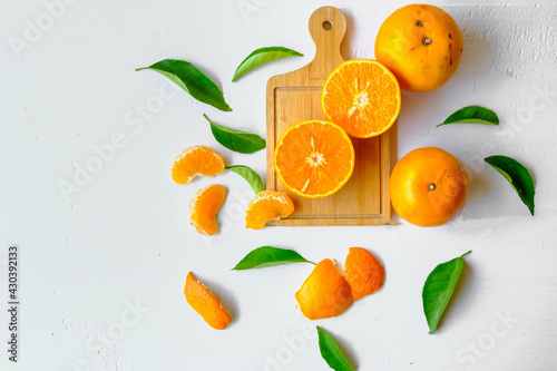 .Fresh citrus fruit with cut oranges and orange leaves. photo