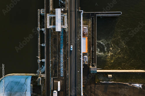 Aerial view of vehicle driving over Kaunas Algirdas Brazauskas Hydroelectric Power Plant near river Neman in Lithuania. photo