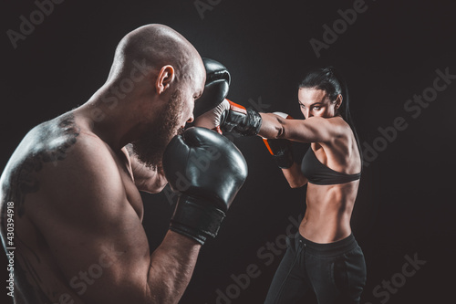 Shirtless Woman exercising with trainer at boxing and self defen © zamuruev