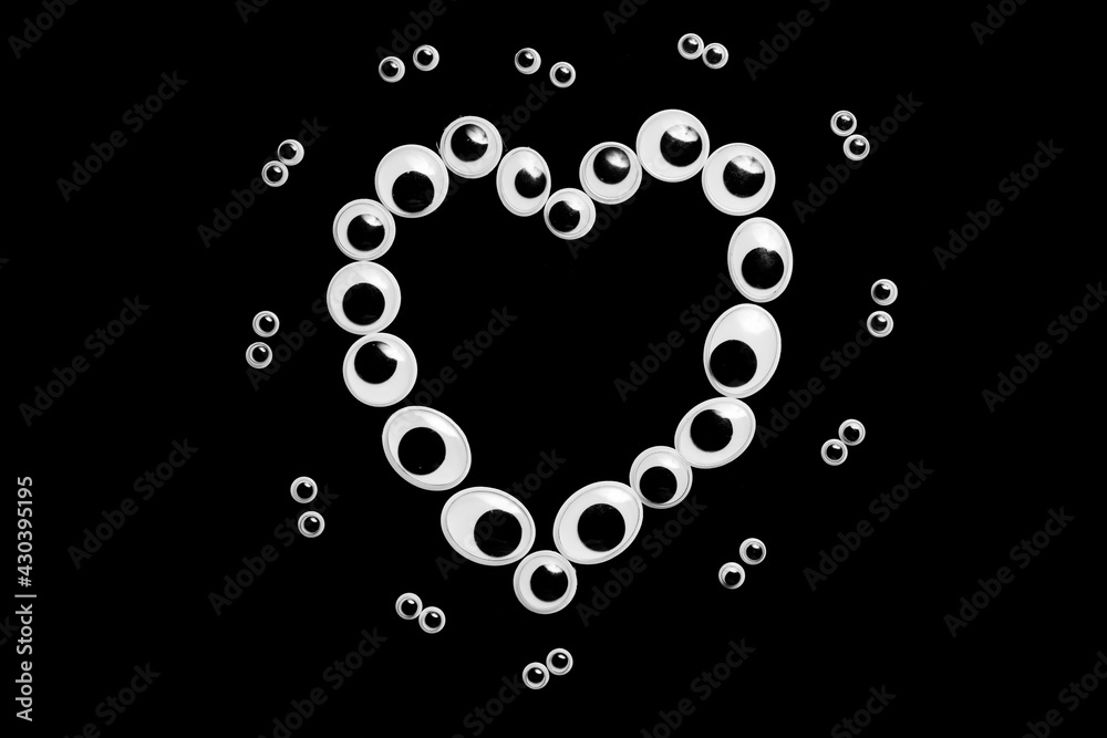 Toy eyes in the form of a heart on a sulfuric background Toy eyes in the form of a heart on a sulfuric background